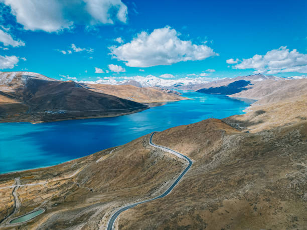 Landscape of Yamdrok Lake with mountains in the background in Tibet.